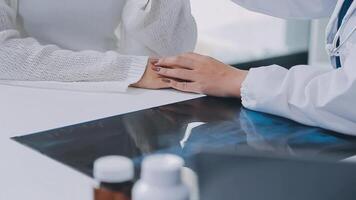 female doctor with female patient and telling advices sitting at workplace in clinic office, Healthcare and medical concept. video