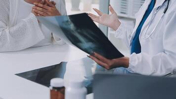 female doctor with female patient and telling advices sitting at workplace in clinic office, Healthcare and medical concept. video