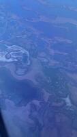 Vertical video from the plane to the ground and ocean near Dubai