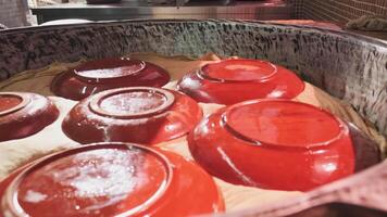 Large pilaf cauldron with steaming rice, covered with cloth and plates video