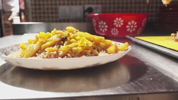 The chef puts the chopped meat in a plate with pilaf and carrots video