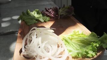 Chef peppering onions on a served board with herbs and vegetables video