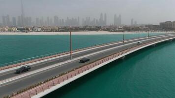 A drone flies over a car traveling on a bridge video