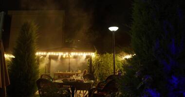 Tashkent, Uzbekistan - 8 4 2022. Night cafe in the open air among Christmas trees. video