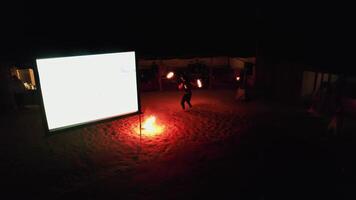 Drone filming a dancer with fire at night on an Arabian carpet video