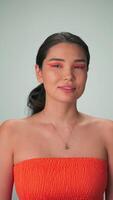 Vertical portrait of a young model with long black hair and bright makeup video