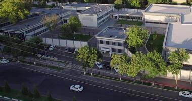 The drone flies over houses surrounded by trees. Summer city during the day. video