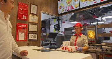 Tashkent, Uzbekistan - 8 4 2022. A visitor picks up an order at the checkout of a small cozy cafe video