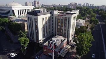 Tashkent, Uzbekistan - 8 4 2022. A drone flies over a fast food cafe in the city on a sunny day video