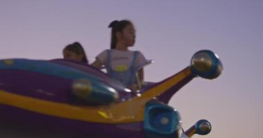 Tashkent, Uzbekistan - 8 4 2022. Children ride a carousel in the form of a rocket in an amusement park video