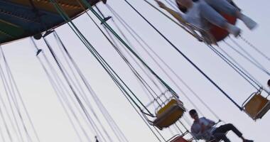 Tashkent, Uzbekistan - 8 4 2022. Visitors to the amusement park ride a carousel video