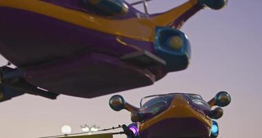 Tashkent, Uzbekistan - 8 4 2022. Children ride a carousel in the form of a rocket in an amusement park video