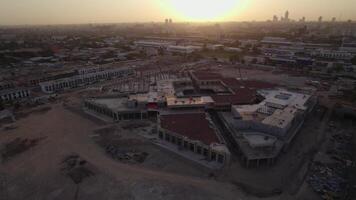 Drone flies over buildings under construction on a sunny day video