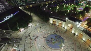 Tashkent, Uzbekistan - 8 4 2022. A drone flies over an amusement park with carousels and a Ferris wheel video