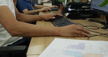 Tashkent, Uzbekistan - 8 4 2022. Close-up of hands of people working at computer and with drawings in architectural design office video