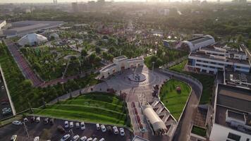 Tashkent, Uzbekistan - 8 4 2022. A drone flies over an amusement park with carousels and a Ferris wheel video