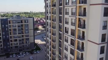 Drone flies over apartment buildings on sunny summer day video