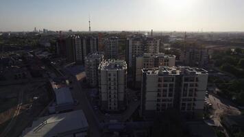 Drone flies over apartment buildings on sunny summer day video