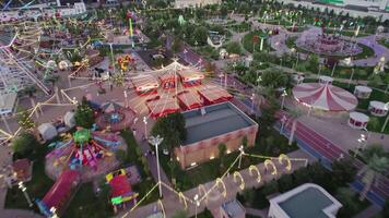 A drone flies over an amusement park with carousels and a Ferris wheel video