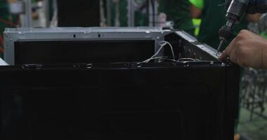 Tashkent, Uzbekistan - 8 4 2022. Close-up of hands of people assembling computer on conveyor belt video