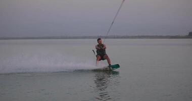 Tashkent, Uzbekistan - 9 7 2022. Wakesurfer rides a board on a lake video