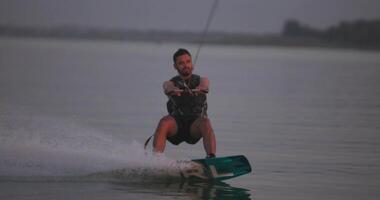 wakesurfista paseos un tablero en un lago video