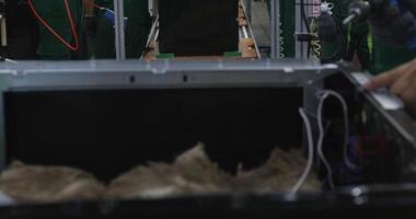 Close-up of hands of people assembling computer on conveyor belt video