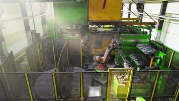 Drone over robotic arm in large factory assembly hall video