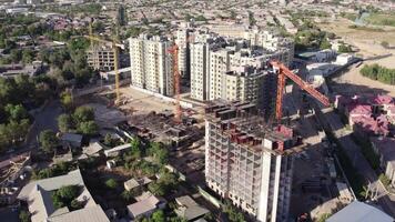 A drone flies over residential apartment buildings under construction video