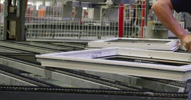 The operator works on a robotic conveyor for the production of plastic windows video