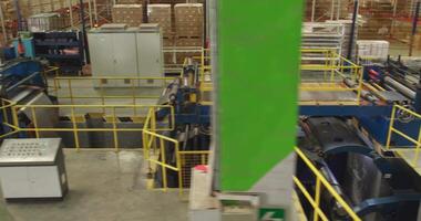 A drone over a sheet metal processing conveyor belt in a large workshop. video