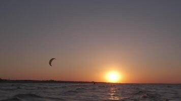 homme sur le kiteboard monte dans le soir video