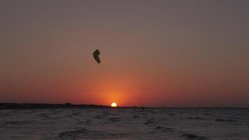 Man on the kiteboard rides in the evening video