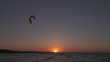 Man on the kiteboard rides in the evening video