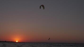 Man on the kiteboard rides in the evening video