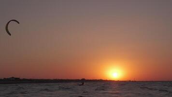 Man on the kiteboard rides in the evening video