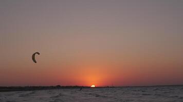 Man on the kiteboard rides in the evening video