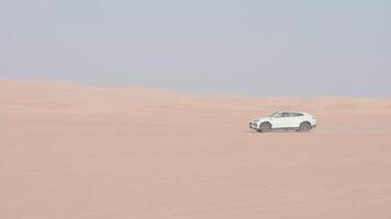 Car is driving in the desert. Dubai, slow motion video