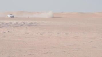 Car is driving in the desert. Dubai, slow motion video