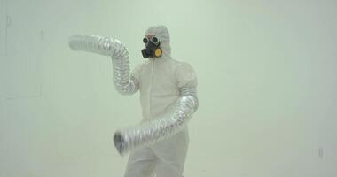 Strange silhouette of man in chemical protection suite with very long sleeves video