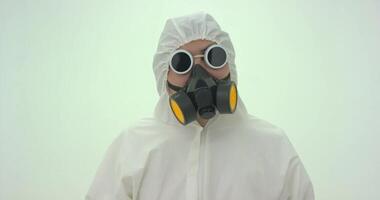 Man in white chemical protection suit takes off his glasses video