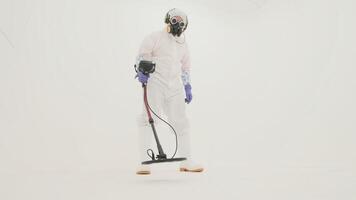 Man in white chemical protection suit holds metal detector video