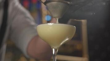 Closeup of straining cream from the shaker to cocktail glass video