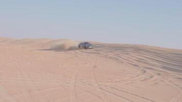 Car is driving in the desert. Dubai, slow motion video