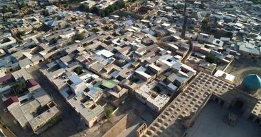 A drone flies over an ancient complex Lyab-i Hauz surrounded by houses in old Bukhara, Uzbekistan. video