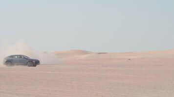 Car is driving in the desert. Dubai, slow motion video