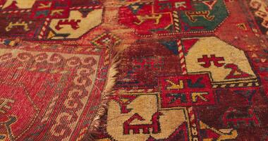 Close up shot of an old shabby handmade carpet made by Samarkand masters using ancient technology. It is covered with national patterns and ornaments. Uzbekistan. video