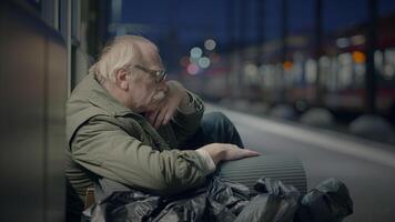 Elderly Homeless Man Suffering from Poverty Looking for Help at Train Station video