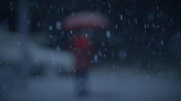 Young African Woman Standing on Street at Night During Snow Fall with Umbrella video