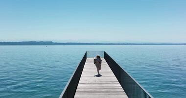 Young African Woman Walking on Bridge Road With Lake Landscape Panorama video